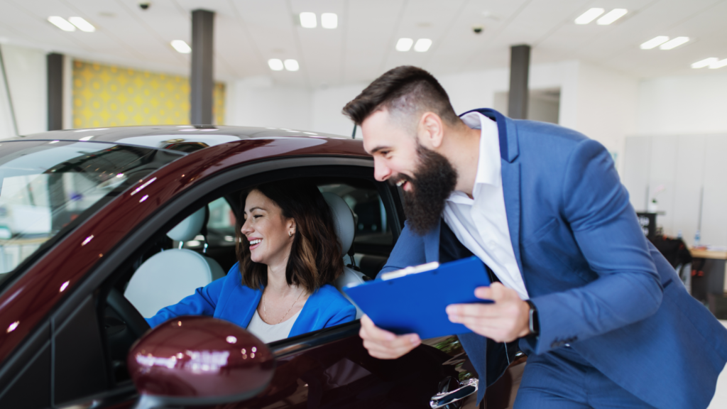 An automotive dealer helps a new customer buy a car
